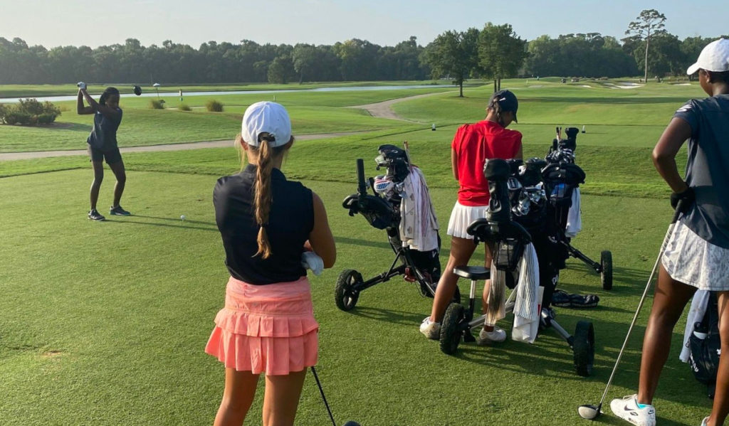 Golfers take turns teeing off