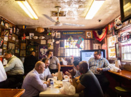 A small dining area in a smokehouse with photos and memorabilia covering the walls