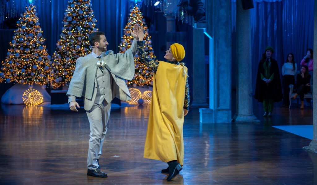 Two performers dance in costume