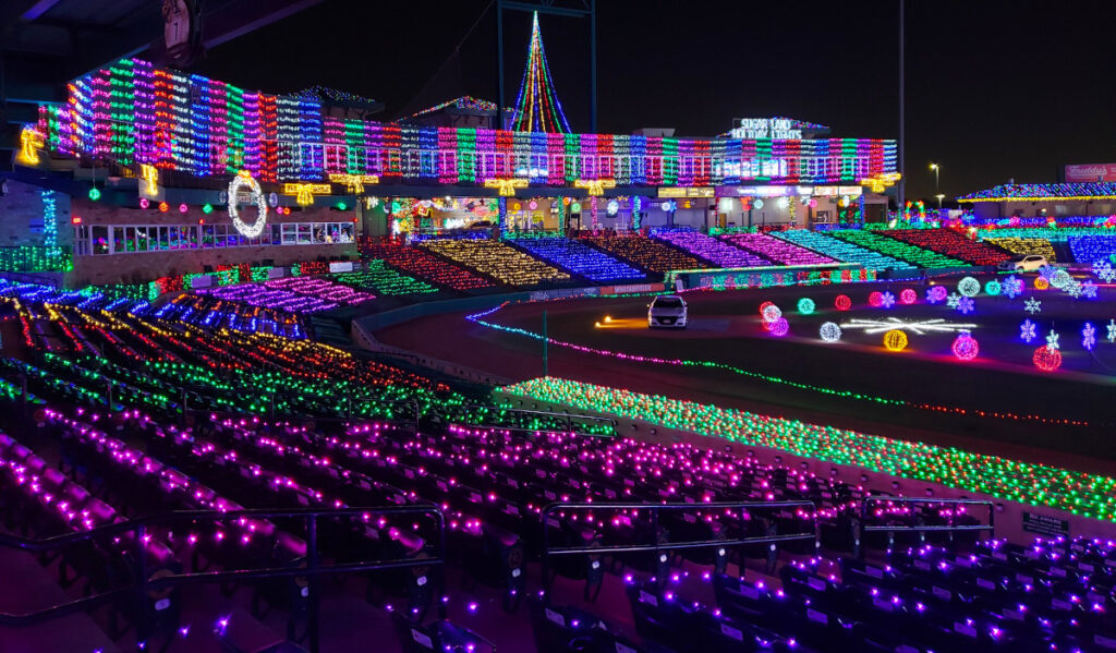 A baseball stadium covered in strings of lights