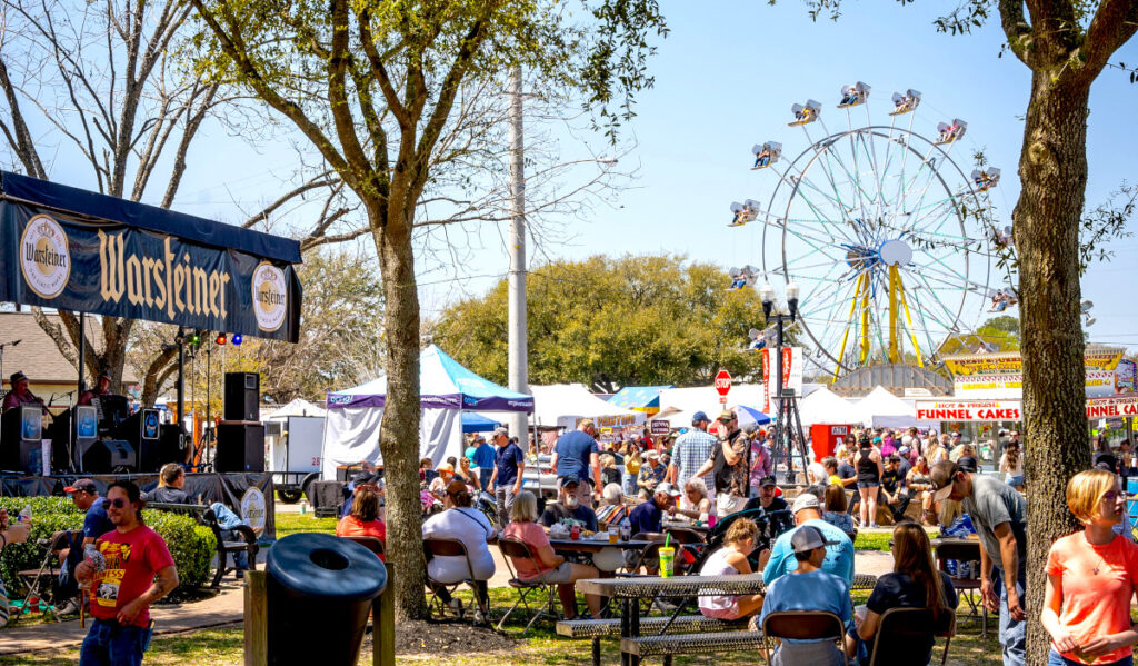 A carnival scene with a ferris wheel, music stage, and food vendors