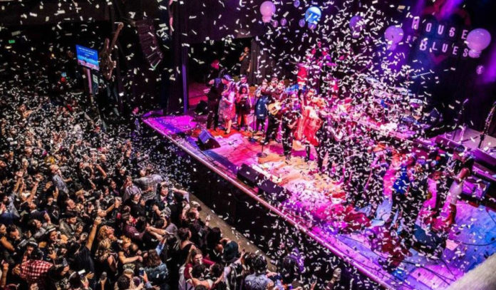 A concert venue with confetti dropping and a large crowd