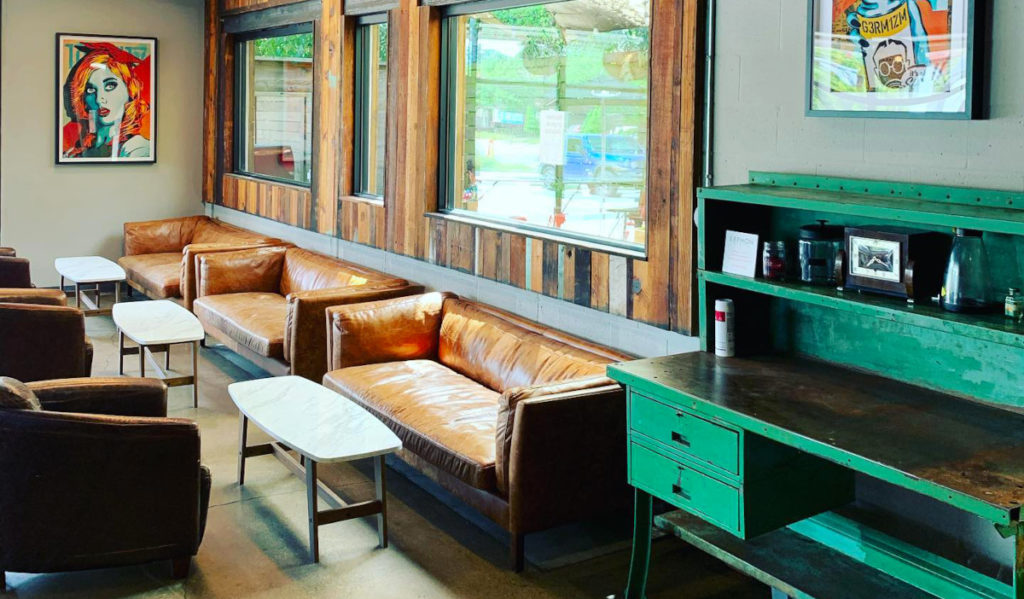 The wall of a coffee shop with couches and low tables