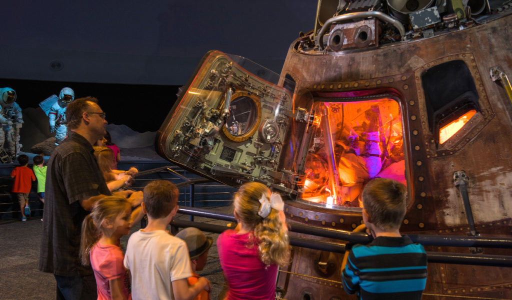 A family gathers around an Apollo 17 space capsule