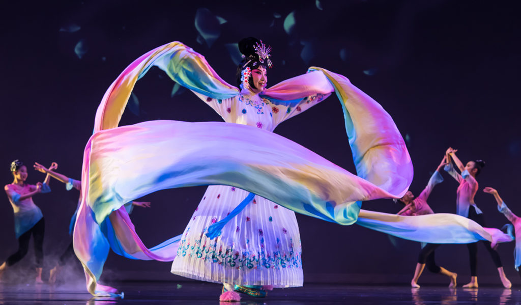 A dancer in cultural regalia performs on stage for Lunar New Year