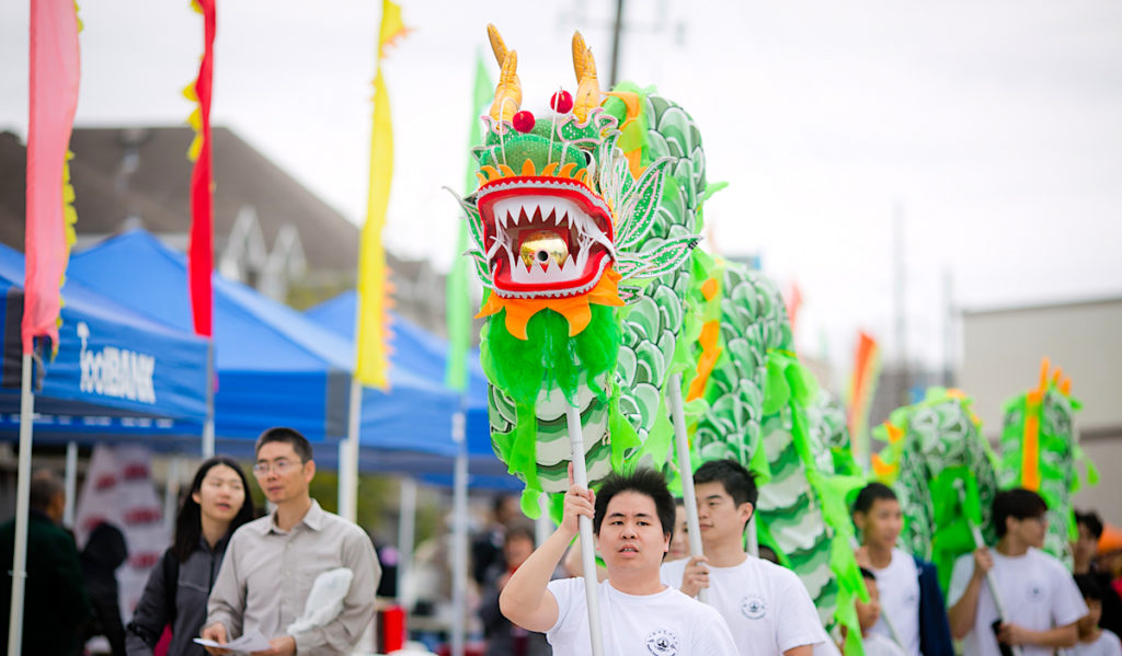 A dragon performance through a market area