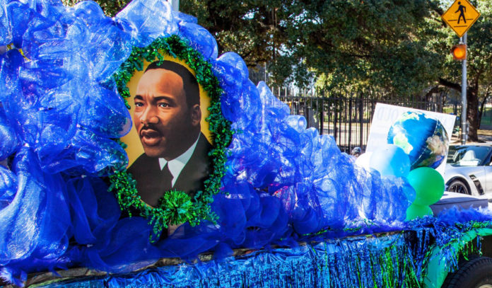 A blue parade float with the image of Dr. Martin Luther King Jr.