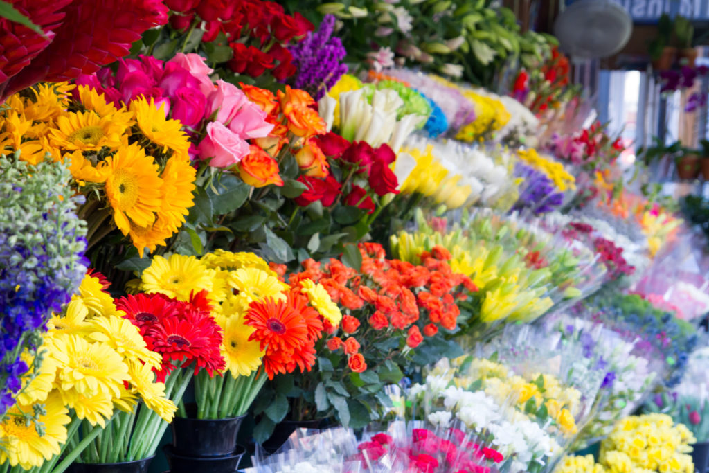 A flower stand with bouquets for sale