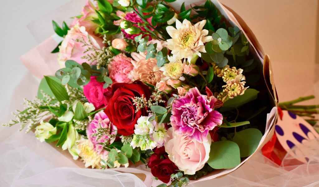 A bouquet of roses, carnations, daisies and many other flowers