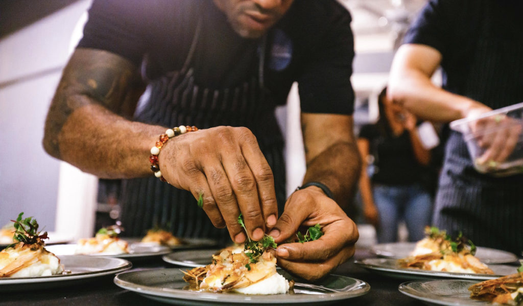 Chef Chris Williams plates a dish in Lucille's kitchen