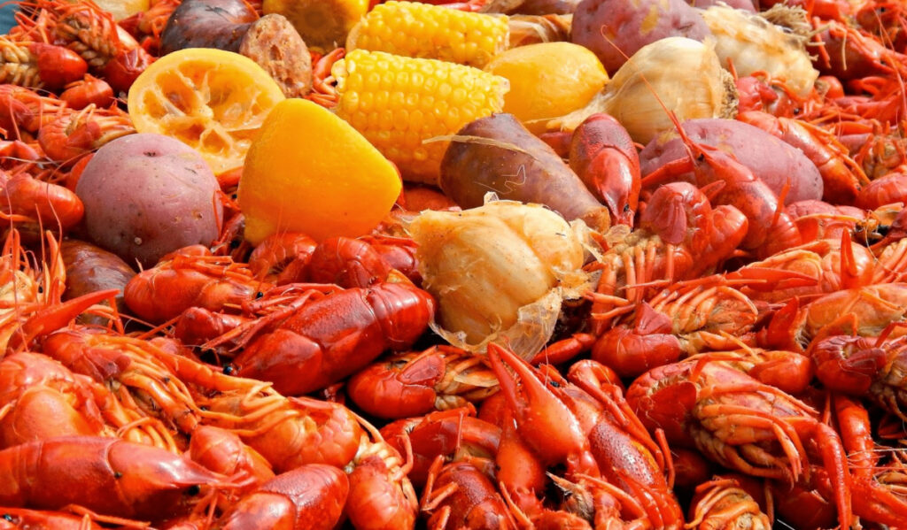 A spread of crawfish, potatoes, garlic, lemon and corn