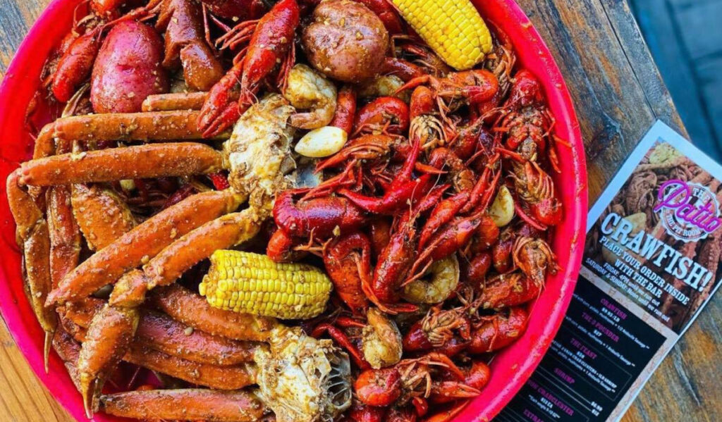 A bowl of seafood, corn, and potatoes