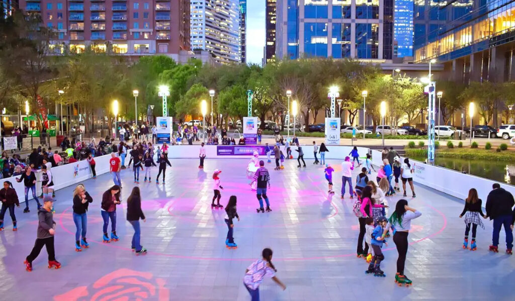 Roller skaters glide around a rink