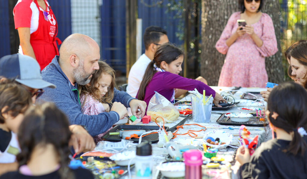 A table of families working on craft projects