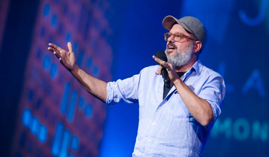 Comedian David Cross gestures while telling a joke