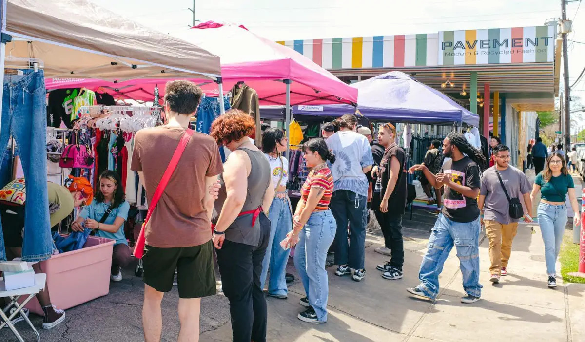 A bustling scene of an outdoor market next to a resale shop