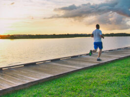 A jogger on a boardwalk on the coast of Nassau Bay