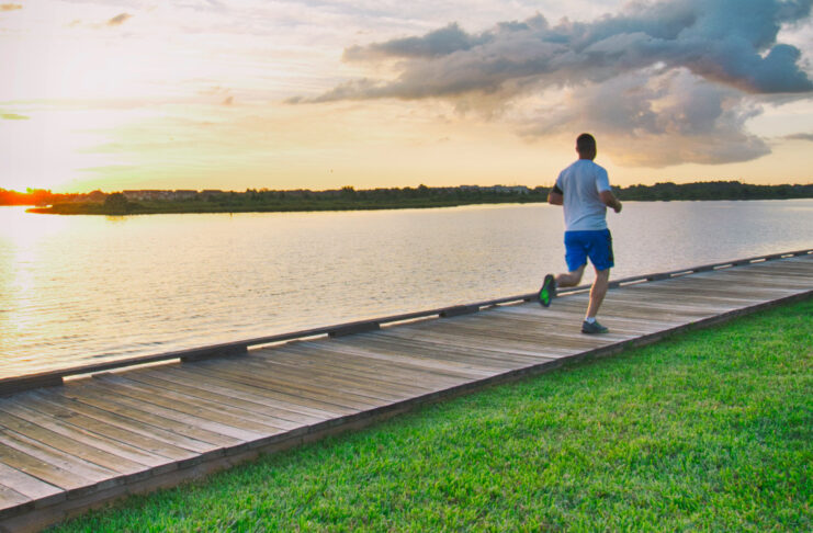 A jogger on a boardwalk on the coast of Nassau Bay