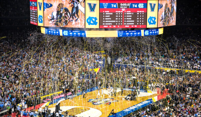 Streamers and confetti falls on a basketball court as the game ends