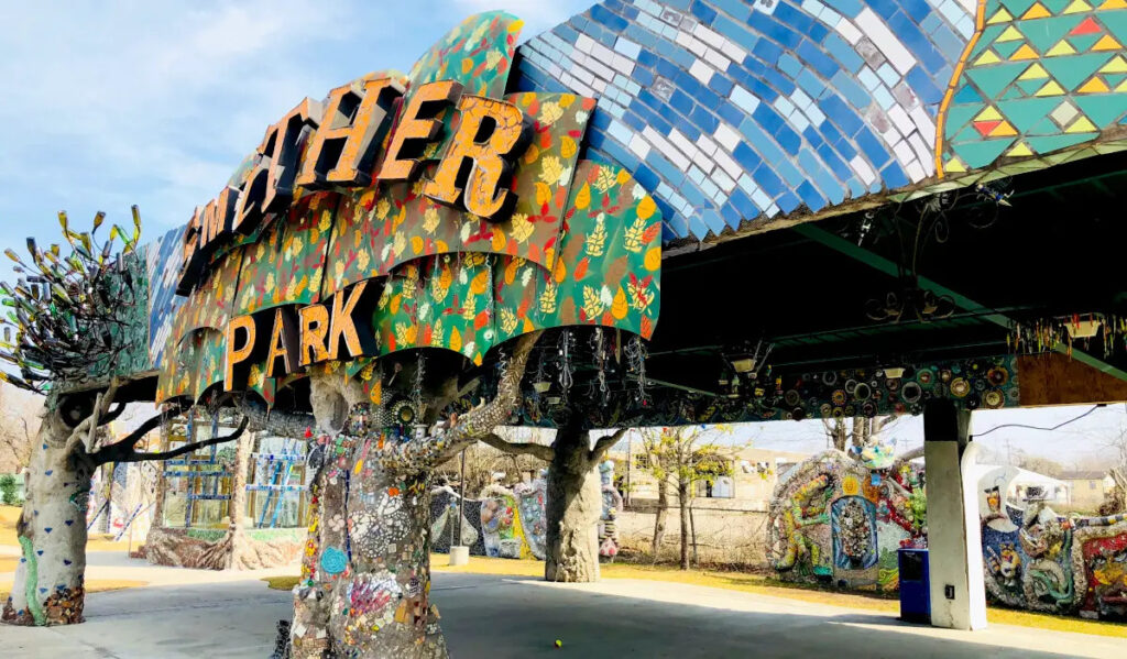 A park pavilion covered in colorful mosaic tiles that spells Smither Park