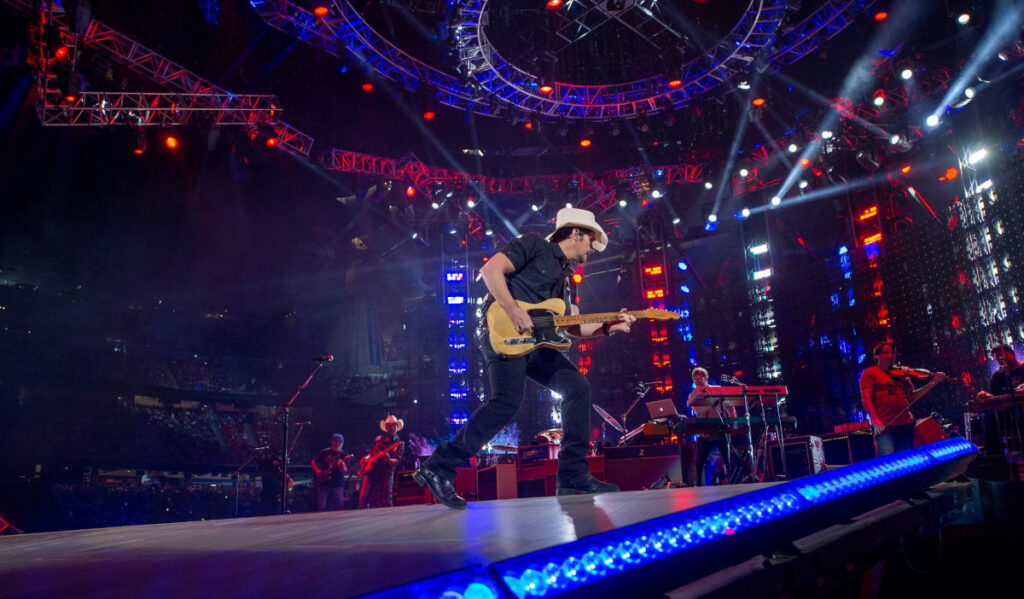 Brady Paisley plays guitar with his band on the Rodeo stage