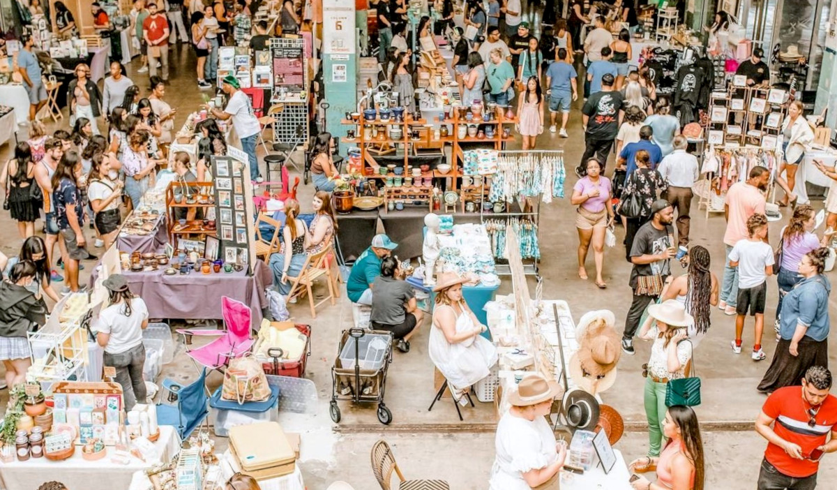 A bustling market scene with vendors talking to passing customers