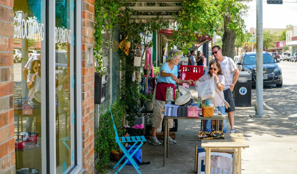 Patrons stop by the front door of a store to shop