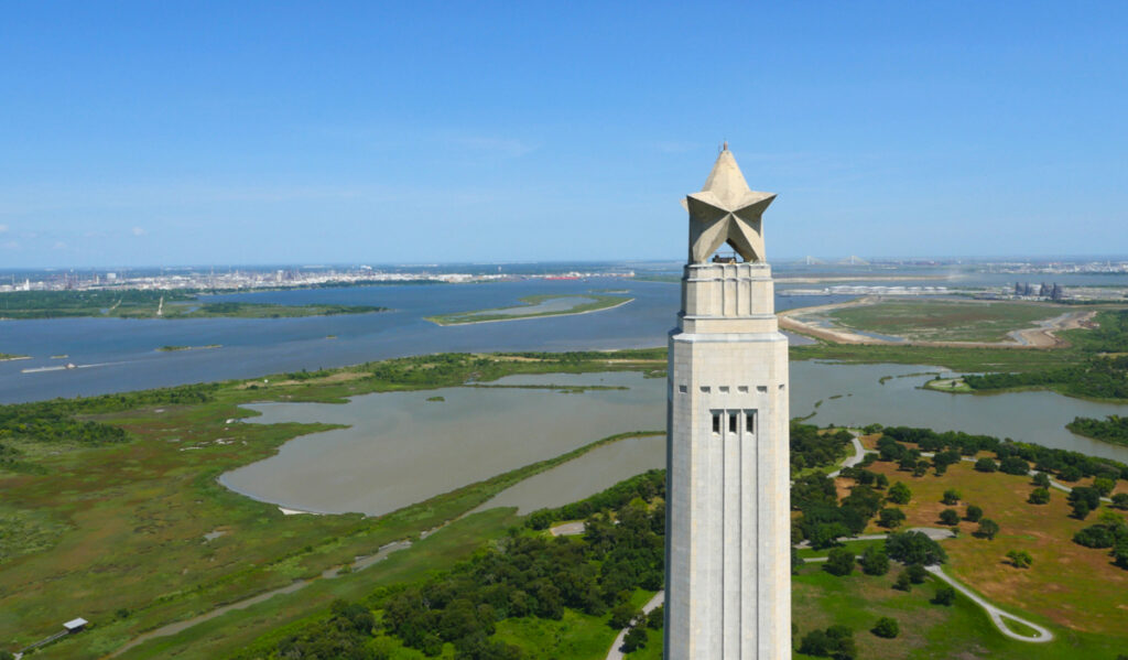 An aerial view of the top of the San Jacinto Monument with a sprawling bay below it