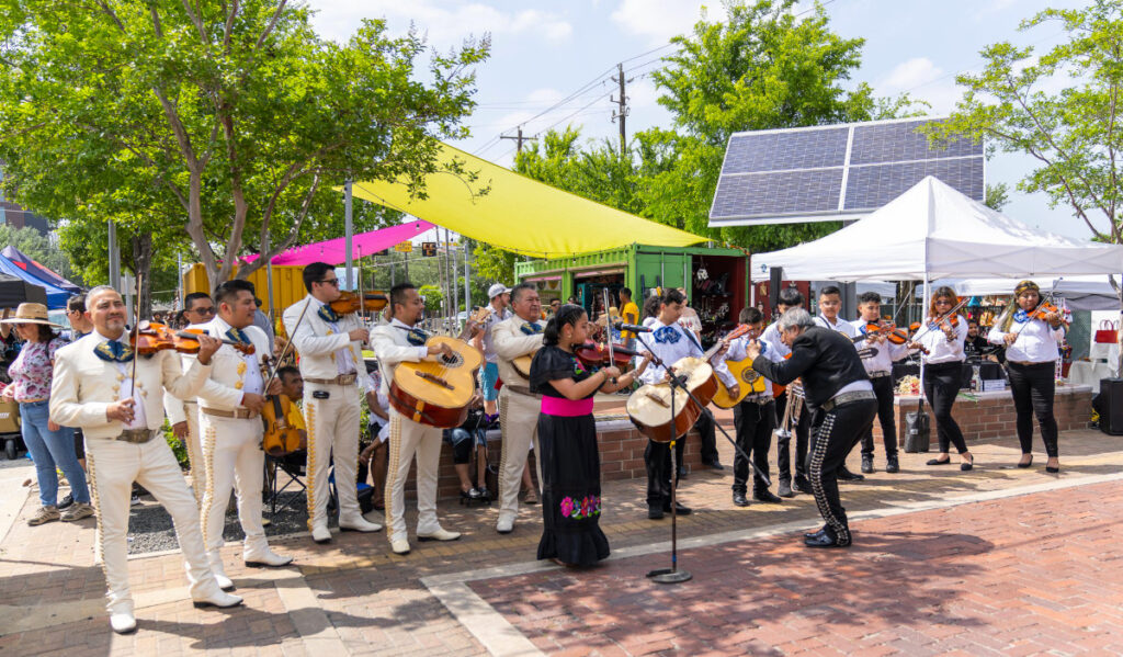 A mariachi group perform at a marketplace