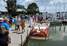 Top 20 Festivals & Events in Houston This Month: May 2025 People walk along a pier past display vehicles and boats