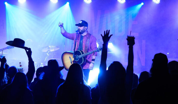sylvan-beach-festival-in-la-porte-houston-2023-wade-bowen-2 Wade Bowen salutes the crowd with a drink in hand while on stage