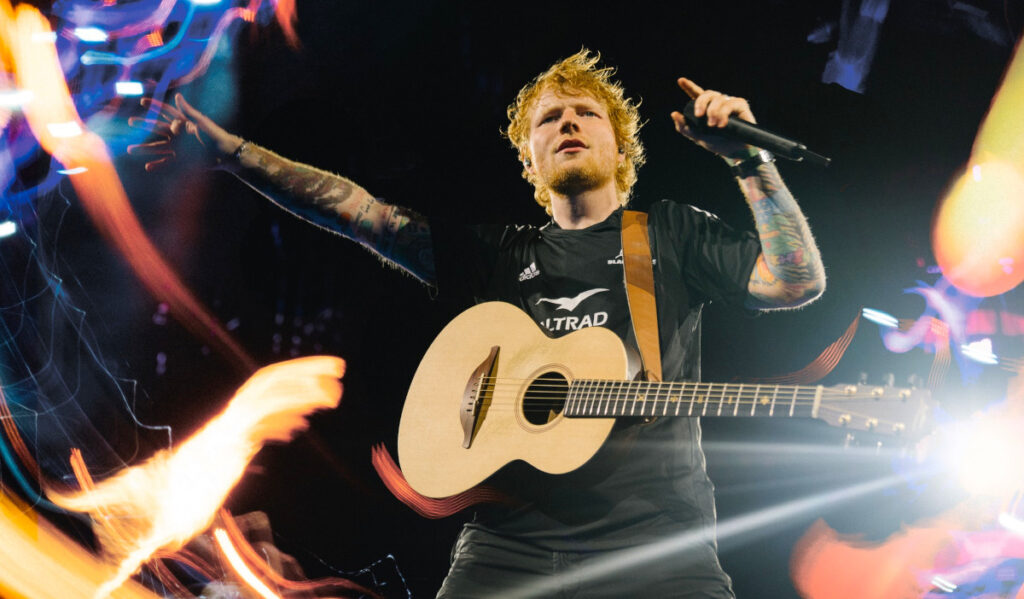 Ed Sheeran sings and performs guitar on stage