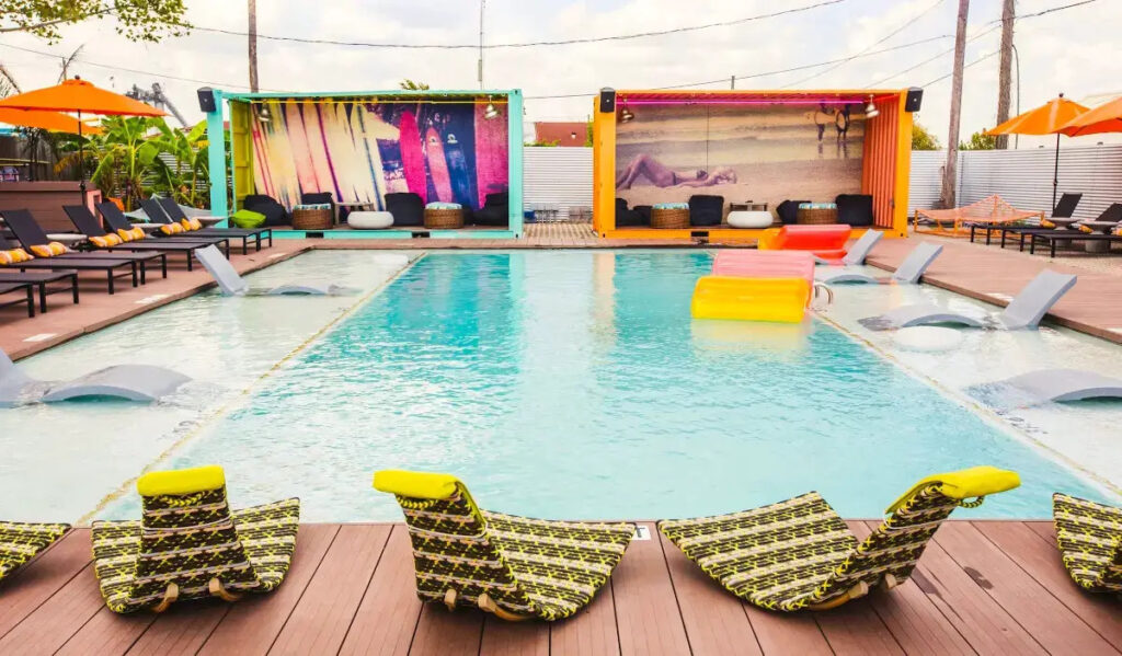 A sunny pool area with lounge chairs and cabanas