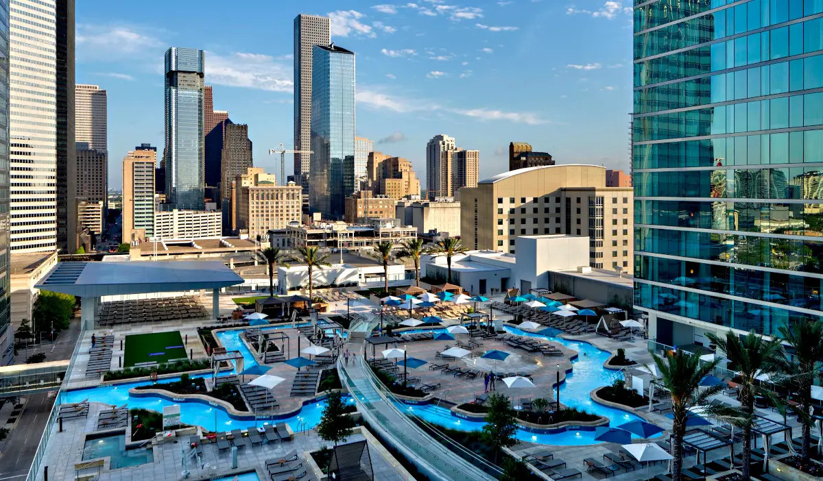 A Texas-shaped pool with skyscrapers in the background