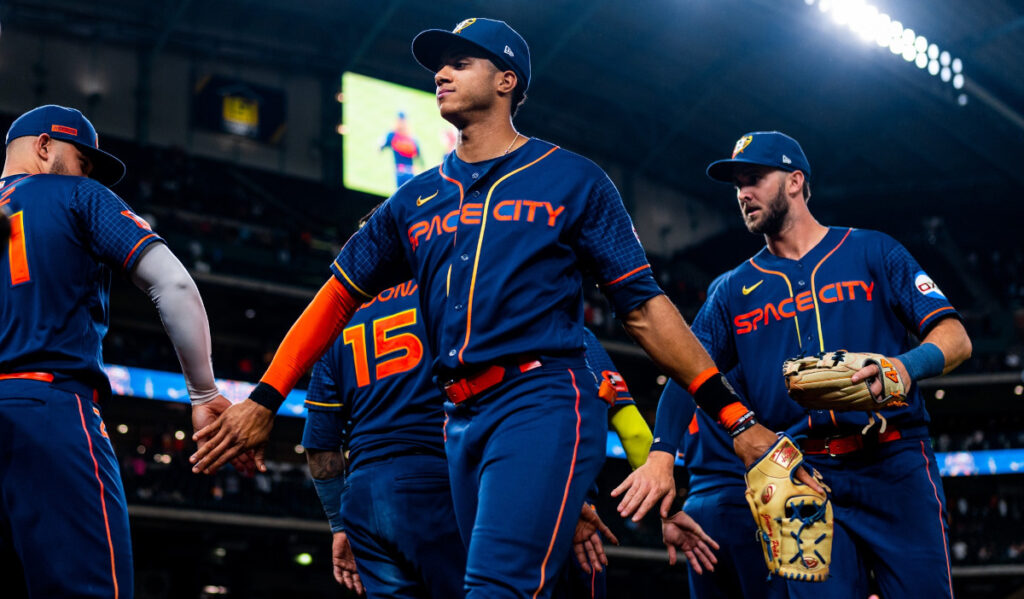 Jeremy Peña and other Astros high five each other after a game