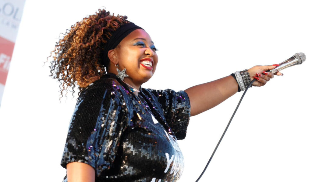 Singer Annika Chambers hold the microphone to the crowd during a performance