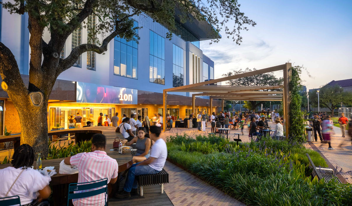 An outdoor scene at the Ion with people gathered at tables and walking around