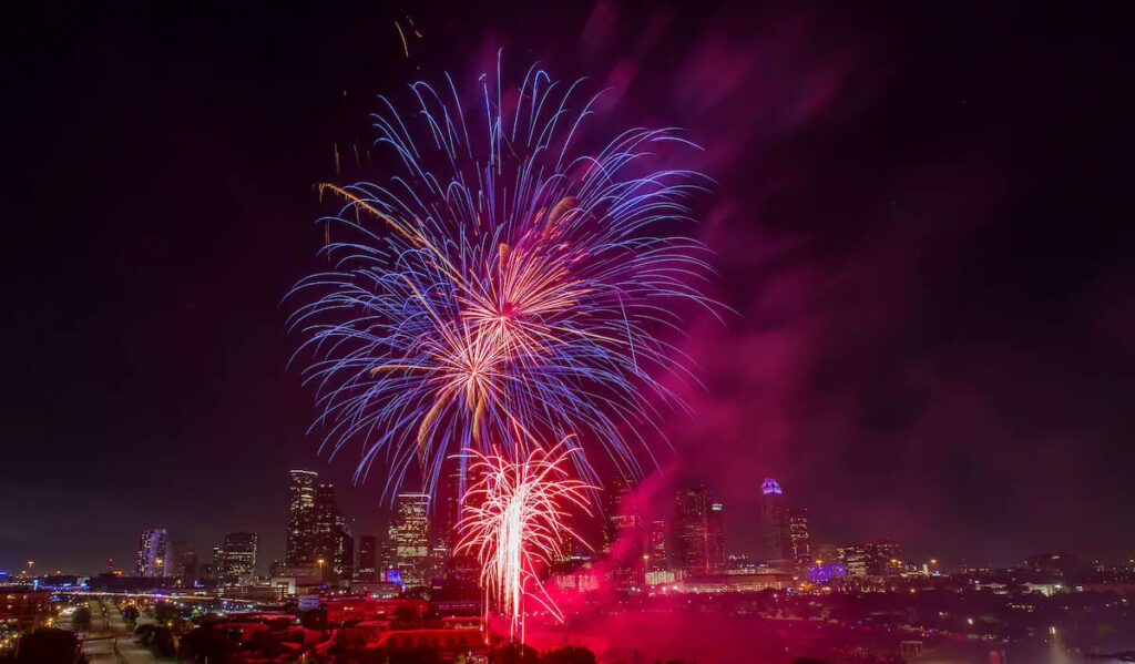 Fireworks exploding over the Downtown Houston skyline