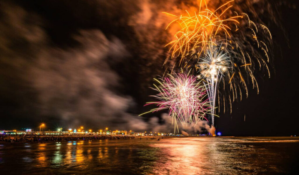 Fireworks exploding over the water of Galveston