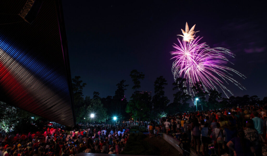 A crowd watches fireworks from Miller Outdoor Theatre