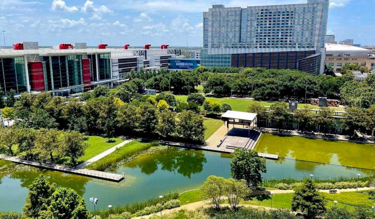 An aerial view of Discovery Green with the George R. Brown Center on the left