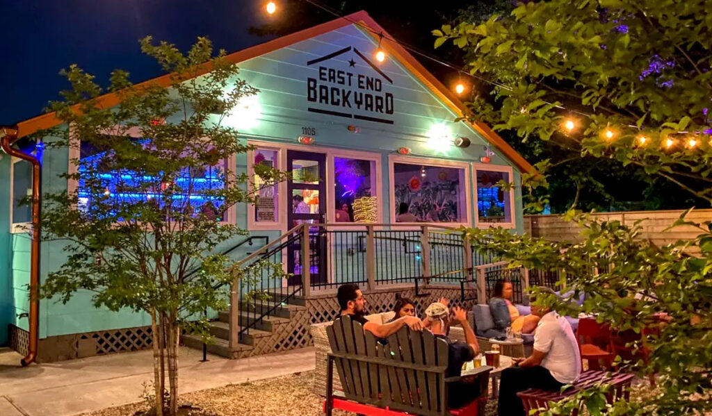 The front entrance to East End Backyard with a group of people chatting near it