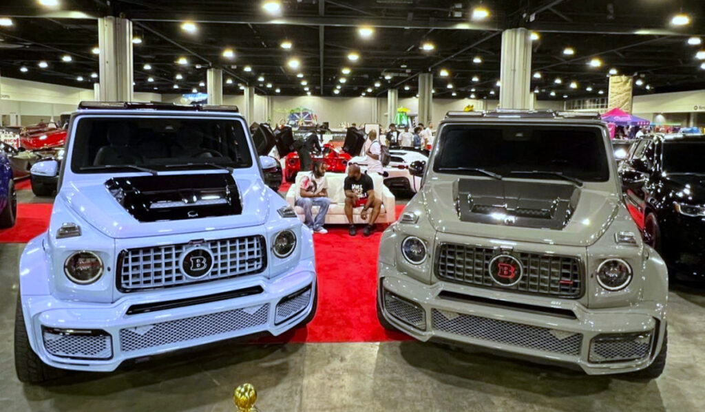 Two custom vehicles in the foreground of a car show 