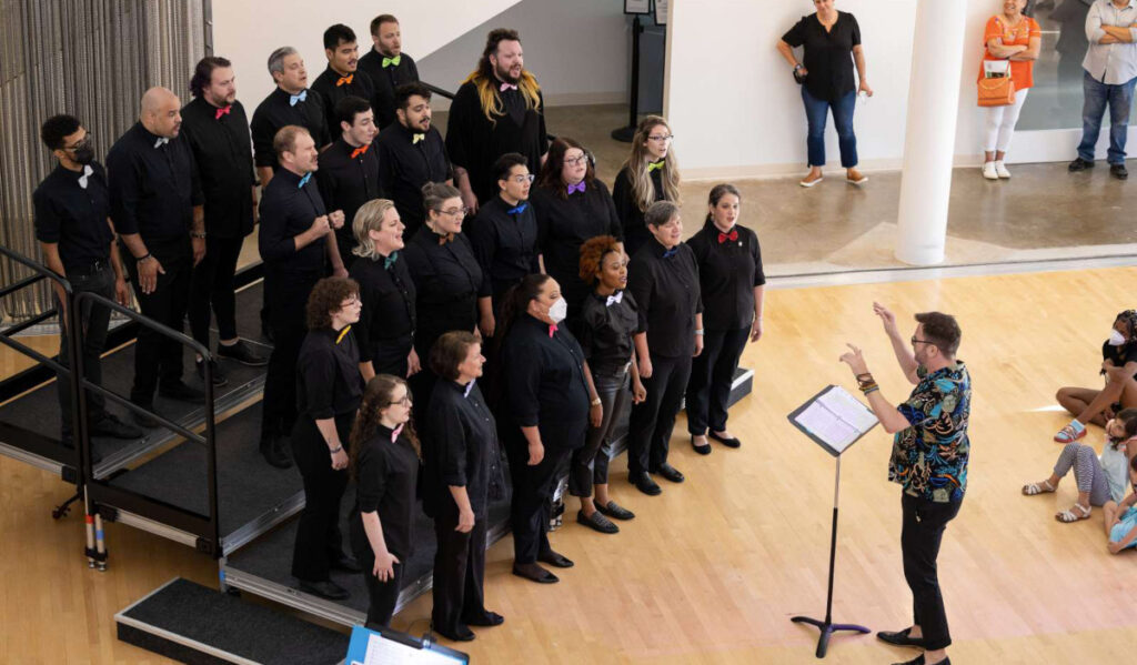 A chorus performs for a small crowd at a museum