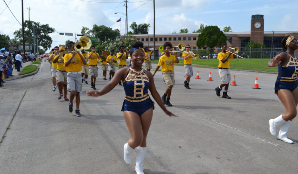 A marching band parades through the streets as part of a Juneteenth celebration