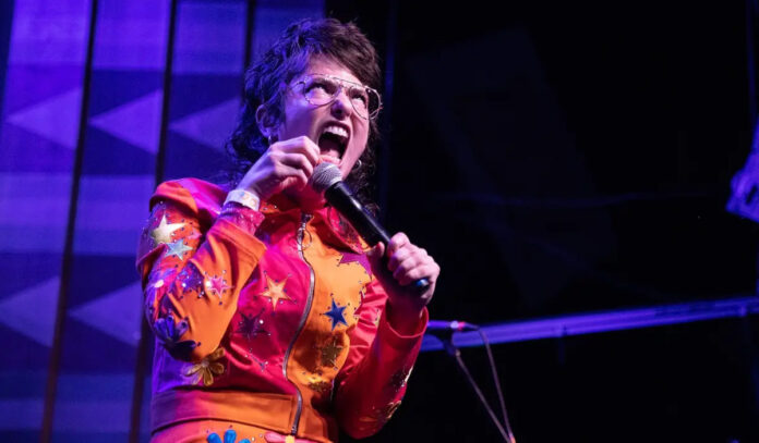 Comedian Sarah Sherman makes a face while performing on stage