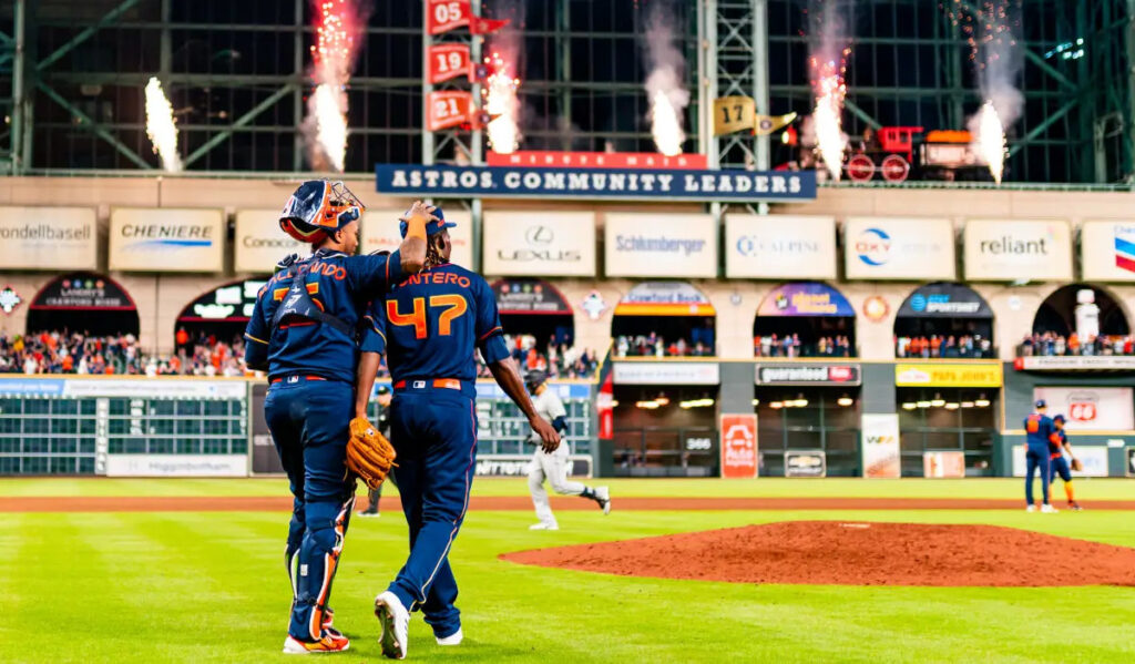 Martin Maldonado and Rafael Montero of the Astros celebrate a victory on the field