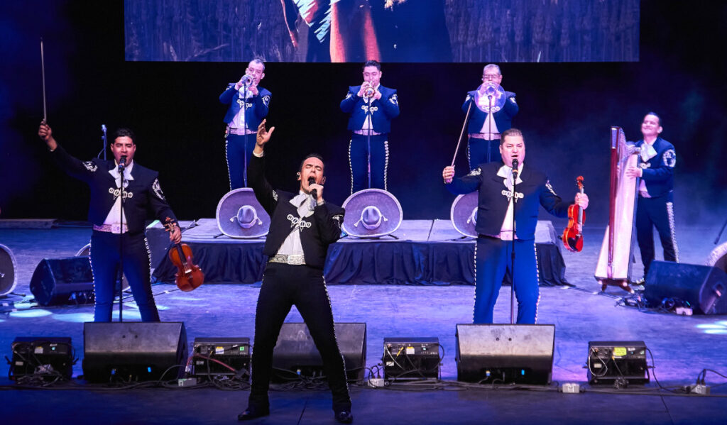 Seven members of Mariachi Vargas de Tecalitlán perform on stage