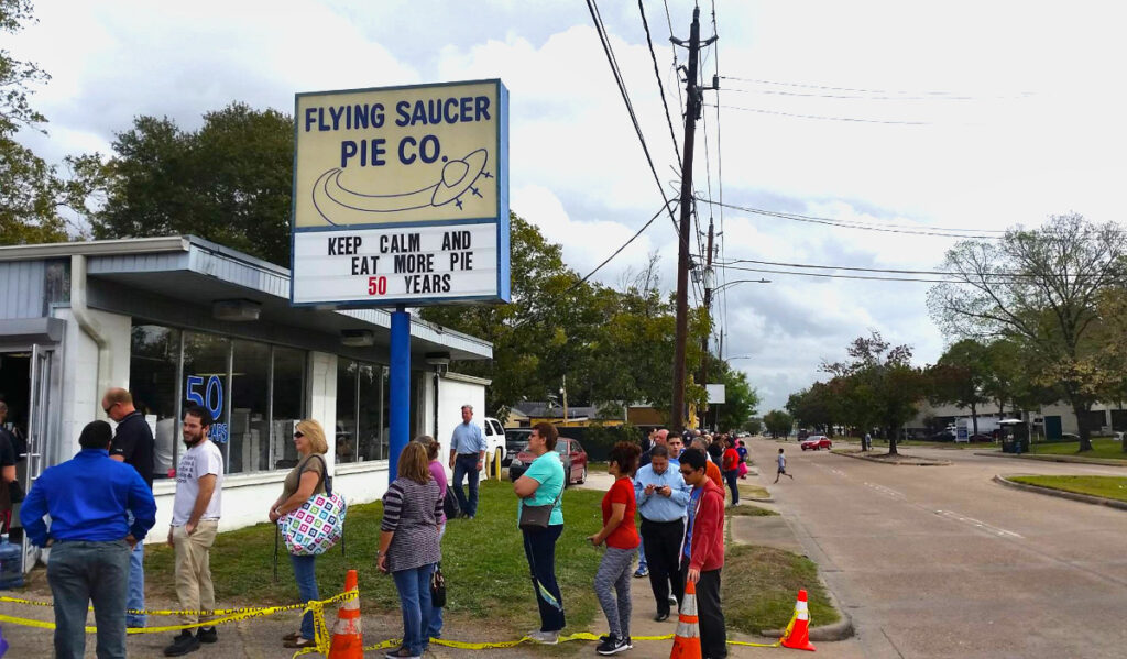 A line of people outside Flying Saucer Pie Co. in Independence Heights