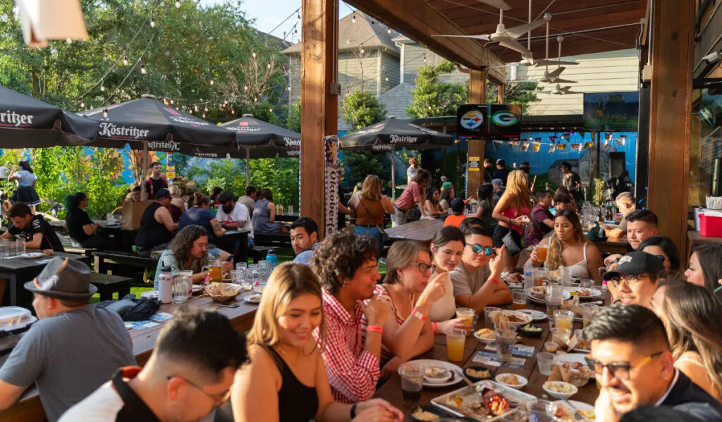 Groups of people sitting at the back patio of King's Bierhaus